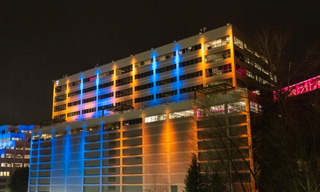 T-Mobile Bellevue headquarters lit up with blue and yellow lighting at night