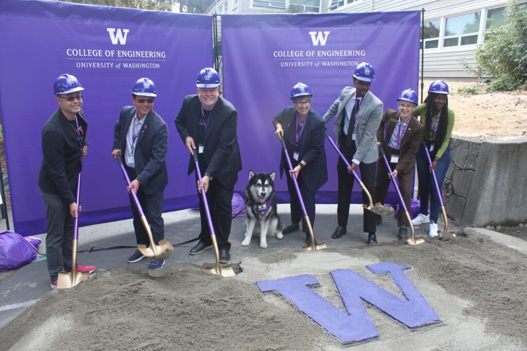 Imagen de T-Mobile and University of Washington officials at the Interdisciplinary Engineering Building groundbreaking ceremony. The people in the image are T-Mobile's Kevin Lau, John Saw, Neville Ray, "Dubs" the Husky, UW President Ana Mari Cauce, UW Engineering student Liban Hussein, Dean Nancy Allbritton, of the UW College of Engineering (wearing brown jacket), and UW Engineering student (in green shirt) Aisha Cora