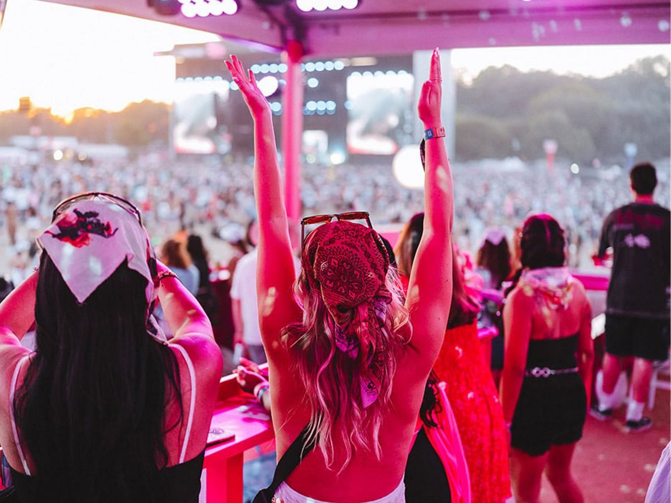 Concert goers raise their hands to the beat.