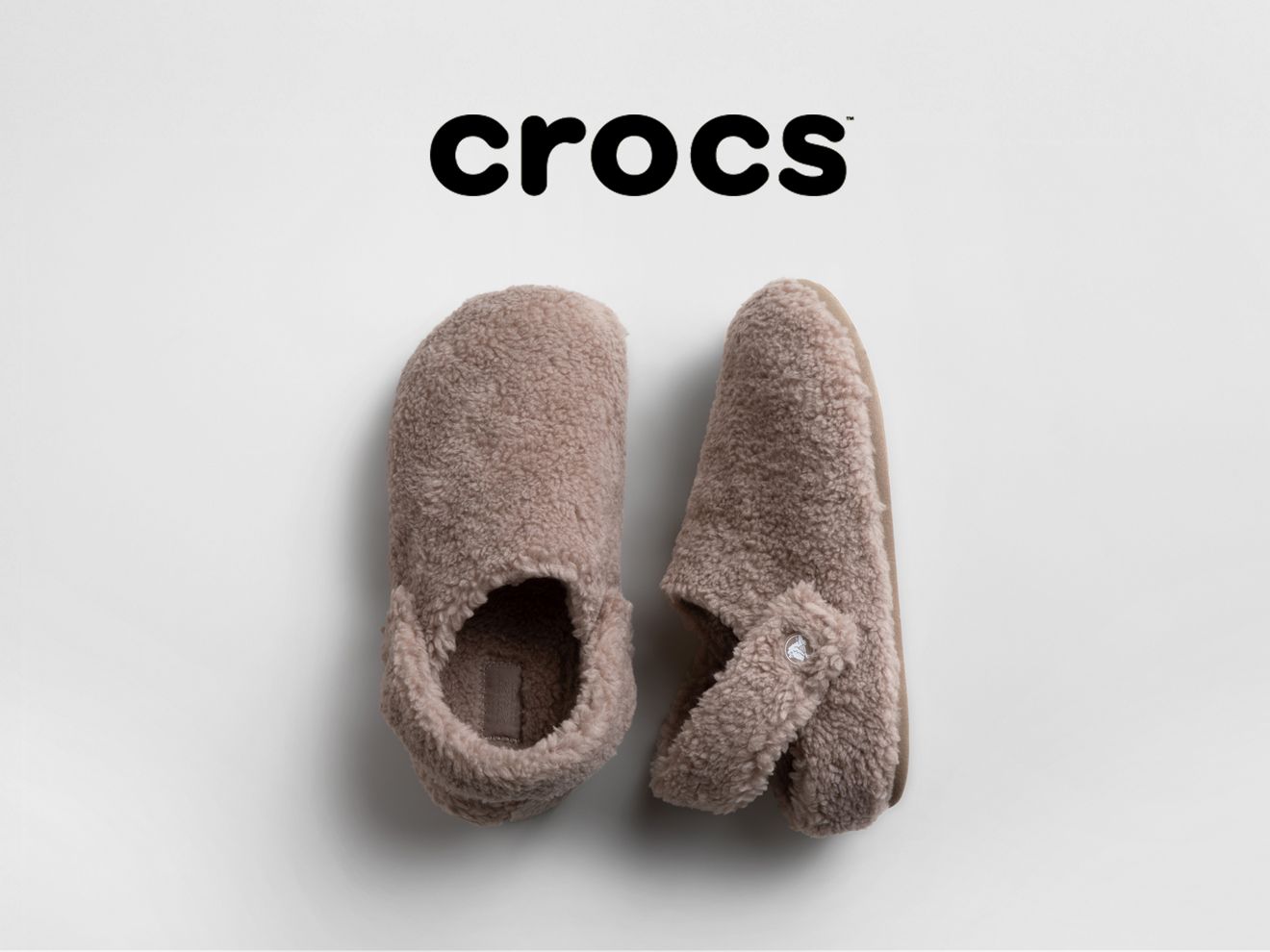 Un par de crocs peludos de color beige.