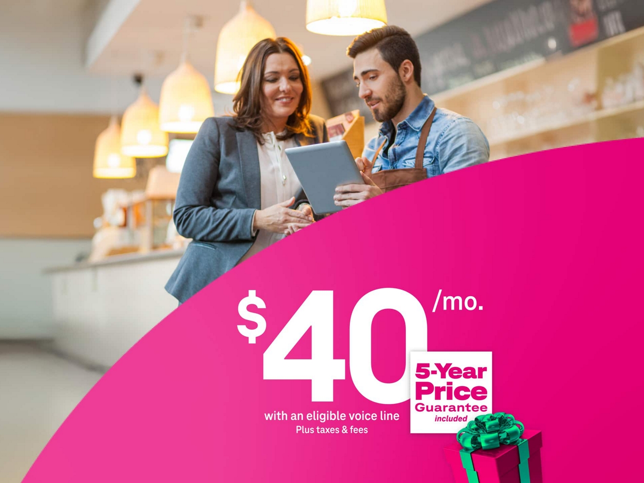 Two cafe workers use 5G Business Internet on a tablet for $40 a month with eligible voice line + taxes & fees, with a 5-year price guarantee and a festive holiday package.