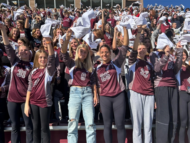 Los estudiantes de Boardman High School y los miembros de la comunidad aplauden con fuerza desde las gradas.