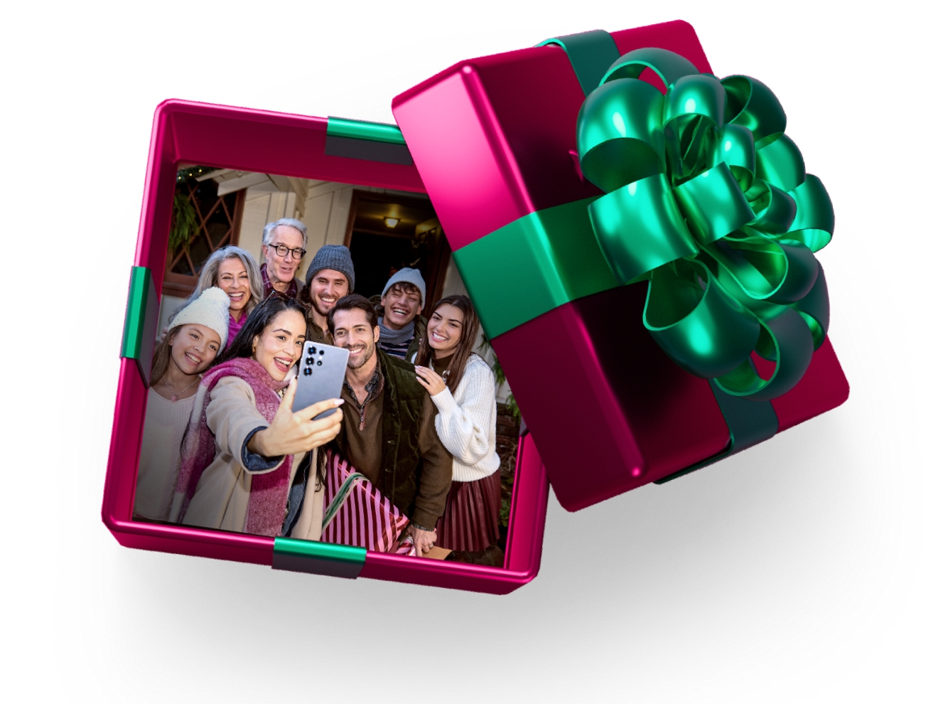 Una caja de regalo magenta con una cinta y un lazo verde esmeralda se abre para revelar un grupo de personas sonrientes tomándose una selfie navideña.