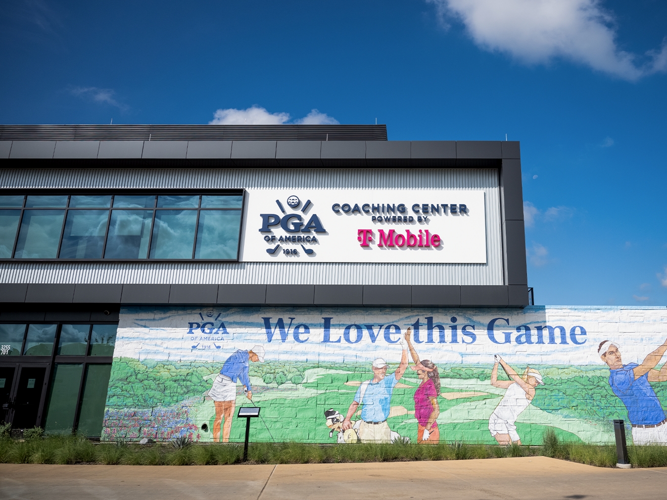 Exterior del edificio del Centro de Entrenamiento de la PGA of America, con un mural con temática de golf.