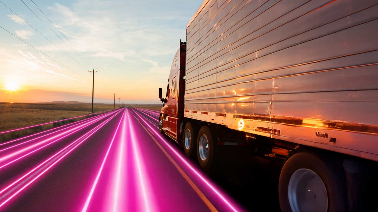 Un semirremolque se traslada a lo largo de una carretera solitaria color magenta al amanecer.