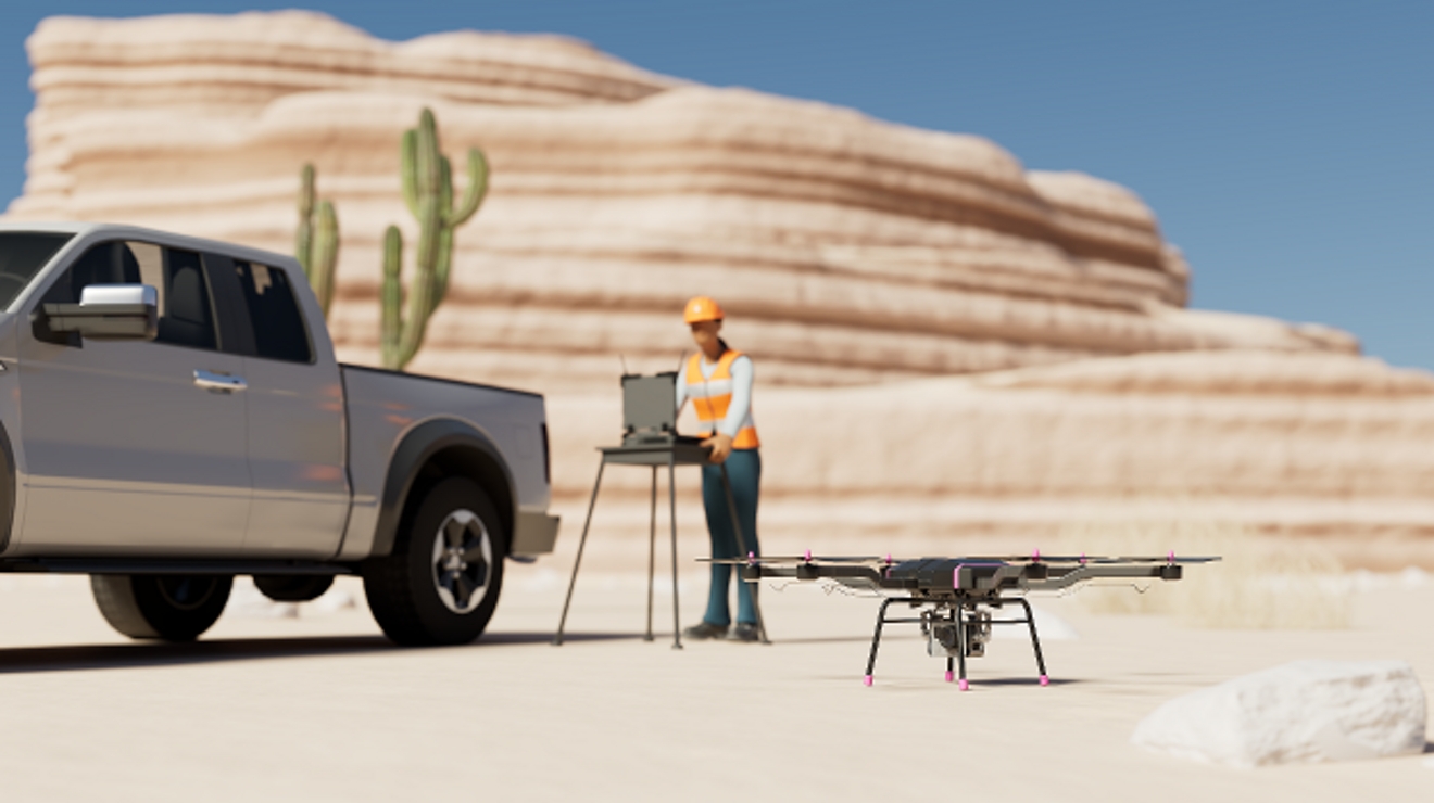 Técnico con una laptop se prepara para lanzar un dron en el desierto.