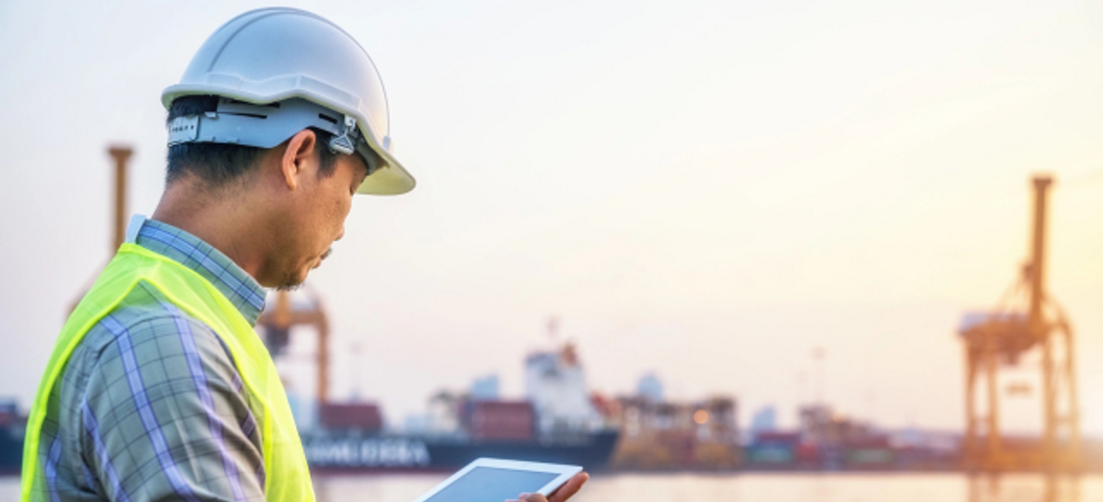 Ingeniero usando una tablet en un puerto.