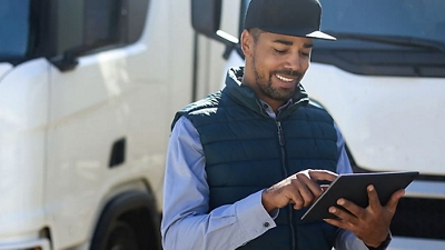 Un repartidor revisa información en su tablet conectada a 5G.