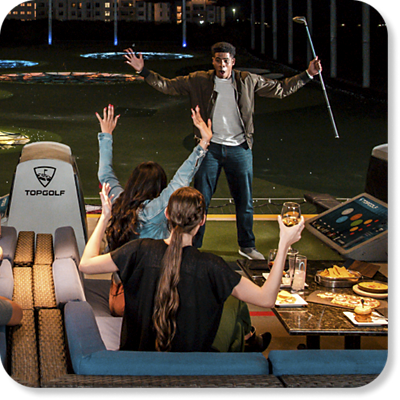 Group of people having fun at Topgolf.