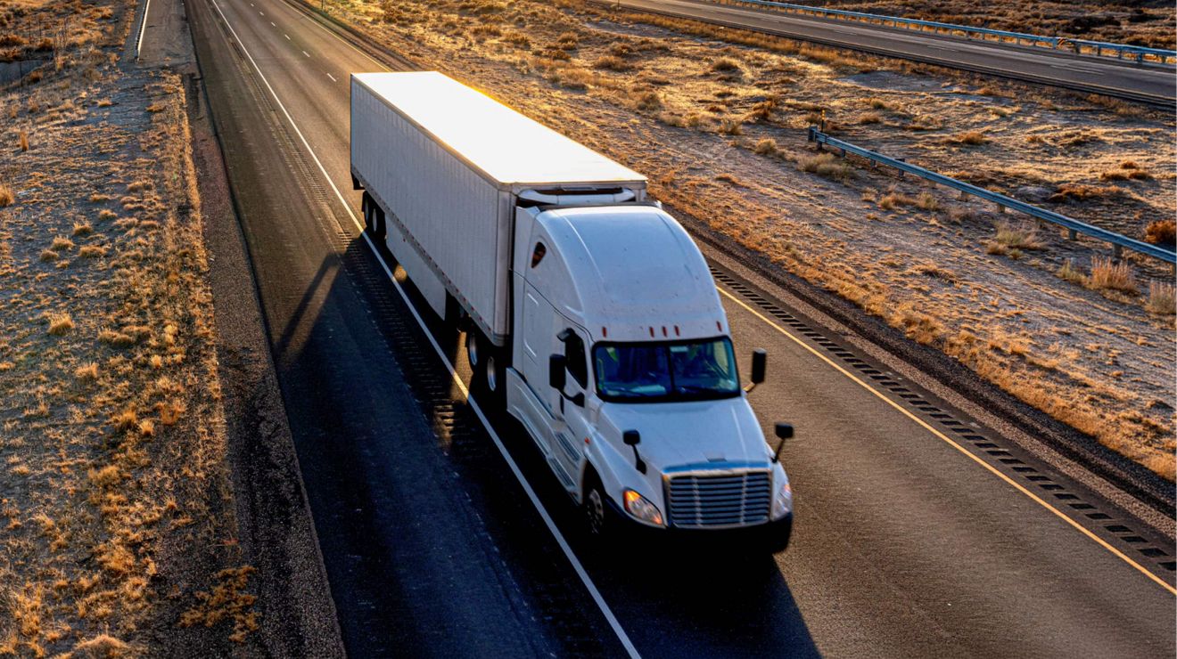 A semi-truck on a rural highway stays connected via the T-Mobile 5G network.