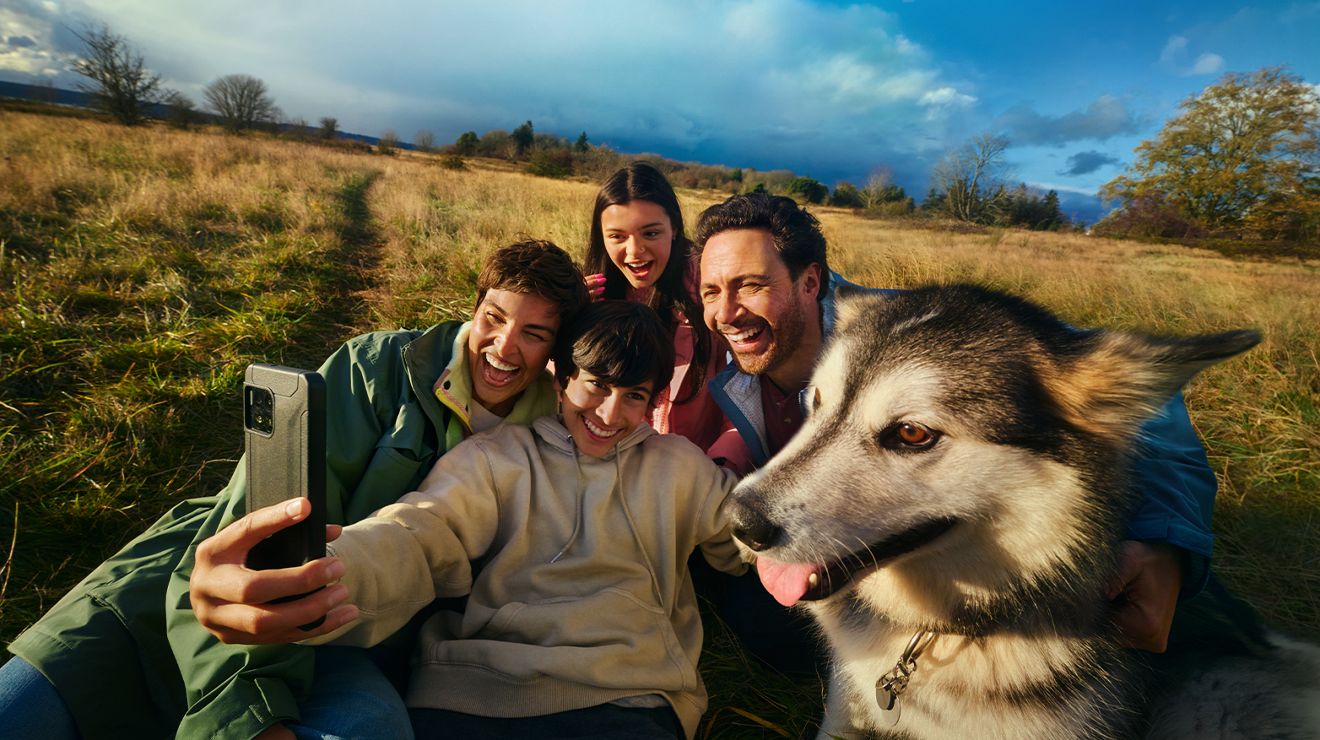 Cuatro personas se toman un selfie con el teléfono.